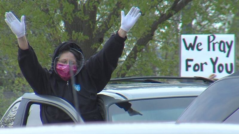 People join in prayer and support from their vehicles.