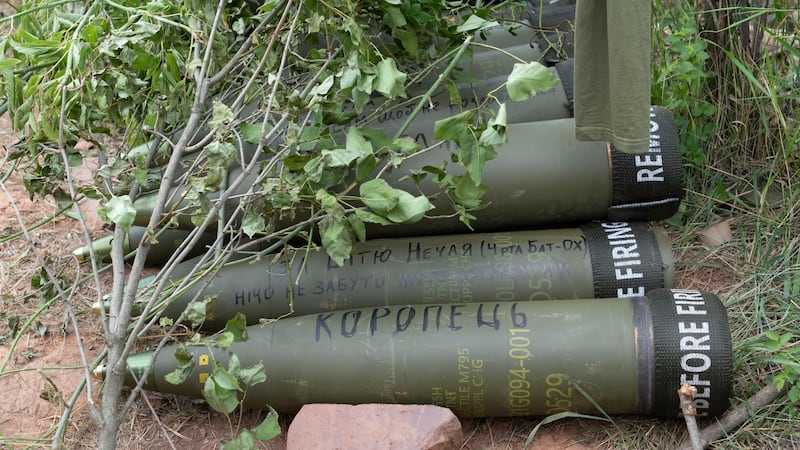 U.S.-supplied M777 howitzer shells lie on the ground to fire at Russian positions in Ukraine's...