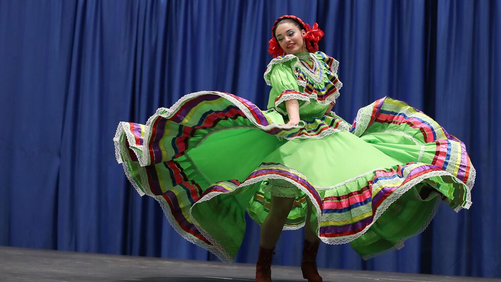 UNK sophomore Marianna Ambriz performs a traditional dance from Guadalajara, Mexico, during...