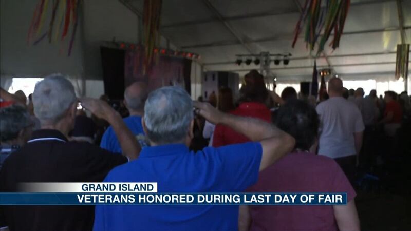 Veterans salute the flag during a morning memorial. (Credit: KSNB)