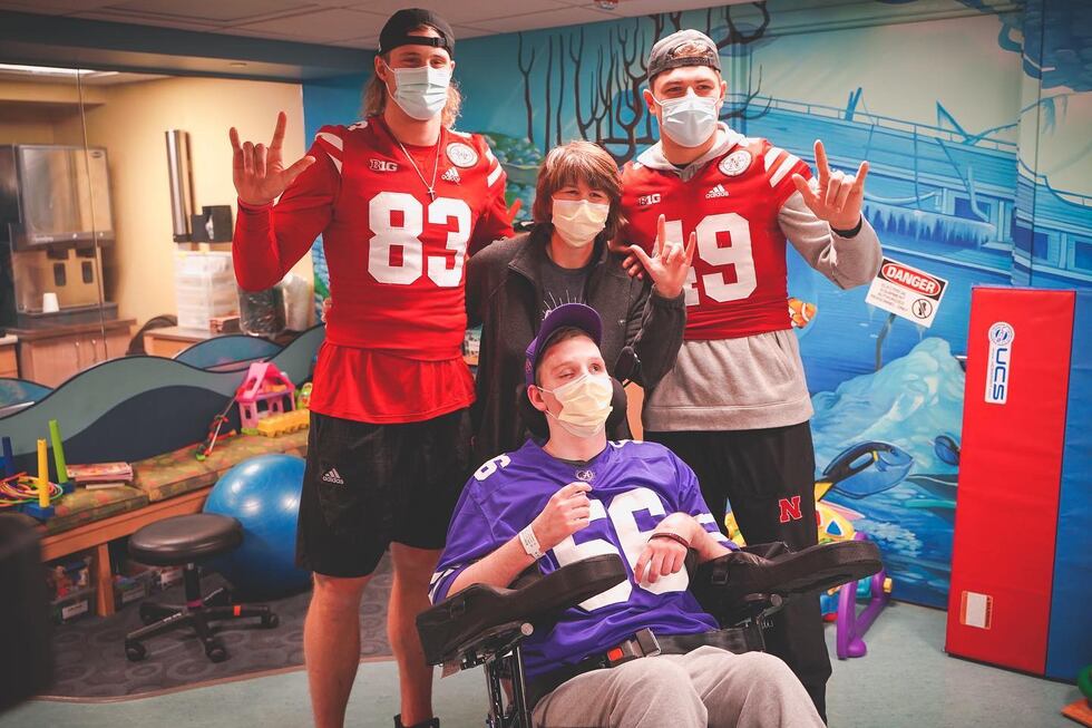 Travis Vokolek (left) and Nate Boerkircher (right) with patient Kyler and his mother.