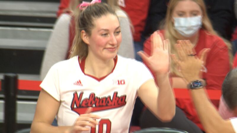 Nebraska volleyball player give a teammate a high five during the Huskers' sweep over Indiana.