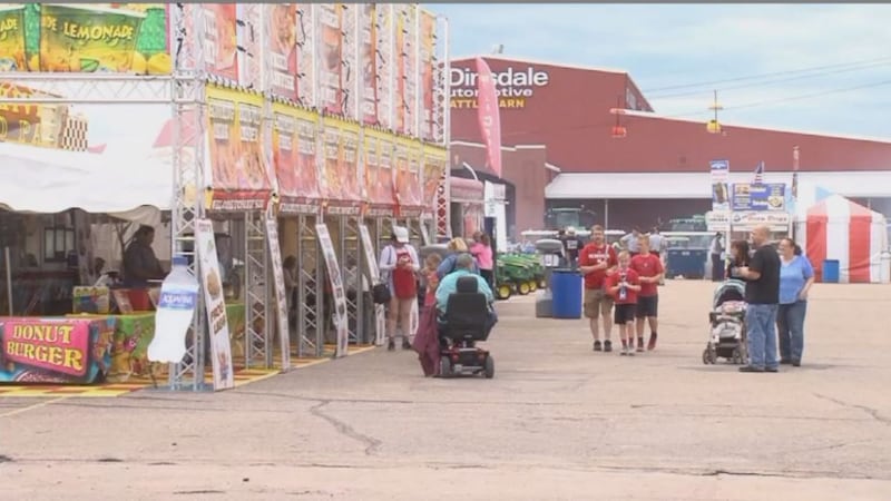 State Fair goers walk through food vendors, enjoying a nice day at Fonner Park. (Credit:...