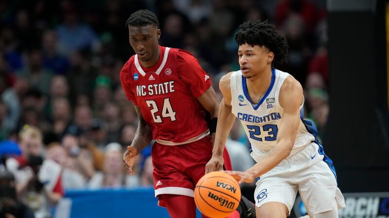Creighton guard Trey Alexander, front, picks up a loose ball as North Carolina State forward...