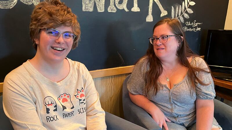 Nola Rhea, 17, left, and her mother, Heather Rhea, 47, sit together in a coffee shop on Sept....
