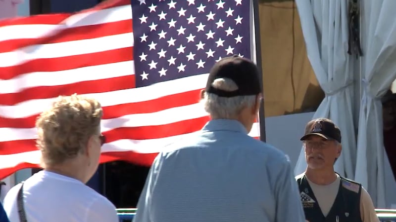A veteran flies the American Flag prior to a State Fair recognition event.