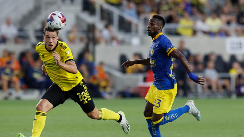 Columbus Crew's Malte Amundsen, left, heads the ball away from Club America's Julian Quinones,...