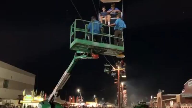 Crews work to get people off of the Nebraska State Fair Sky Tram after it stopped working...