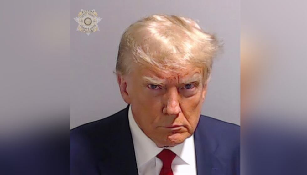 This booking photo provided by the Fulton County Sheriff's Office shows former President...