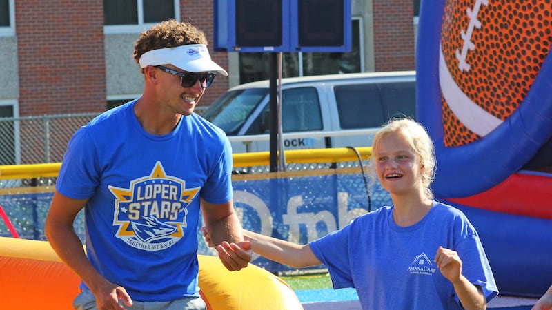 UNK football player Hunter Kraus assists with an activity during Sunday’s Loper Stars event at...